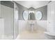 Bright bathroom with gray walls, white tile, patterned floors, large windows, and glass enclosed shower at 12208 Island Dr, Indianapolis, IN 46256