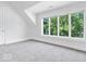 Cozy bedroom with plush carpeting and large windows offering views of the lush greenery outside at 12208 Island Dr, Indianapolis, IN 46256
