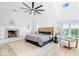 Bright bedroom with vaulted ceiling, decorative fireplace, and large windows at 12208 Island Dr, Indianapolis, IN 46256