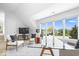 Bedroom offers expansive windows showcasing beautiful outdoor views and comfortable chairs at 12208 Island Dr, Indianapolis, IN 46256