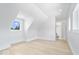 Spacious room featuring vaulted ceilings, base molding, and hardwood flooring and an open door at 12208 Island Dr, Indianapolis, IN 46256