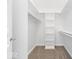 A walk in closet features neutral carpet, shelving, and clothes racks at 12208 Island Dr, Indianapolis, IN 46256