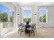 Dining area features a modern table and chairs set with large windows and glass doors at 12208 Island Dr, Indianapolis, IN 46256
