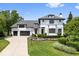 Elegant two-story home featuring a manicured lawn and an attached two car garage at 12208 Island Dr, Indianapolis, IN 46256