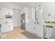 Bright kitchen features white cabinetry, stainless appliances, and white herringbone backsplash at 12208 Island Dr, Indianapolis, IN 46256