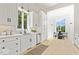 Modern kitchen with white cabinets, a large window, and stainless steel appliances at 12208 Island Dr, Indianapolis, IN 46256