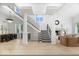Bright and airy living room featuring a fireplace, staircase, and modern decor at 12208 Island Dr, Indianapolis, IN 46256