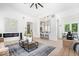Open-concept living room with modern fireplace, kitchen bar, and hardwood flooring at 12208 Island Dr, Indianapolis, IN 46256