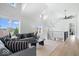 Open-concept living room with high ceilings, neutral furniture, and large windows at 12208 Island Dr, Indianapolis, IN 46256