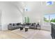 Bright living room with high ceilings, large windows, and stylish gray sofas at 12208 Island Dr, Indianapolis, IN 46256