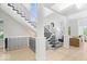 Well-lit staircase with metal railing and hardwood flooring, flooded with natural light at 12208 Island Dr, Indianapolis, IN 46256