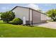 A well-maintained barn with light and dark gray siding, surrounded by lush green grass and landscaping at 12251 E 196Th St, Noblesville, IN 46060