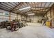 Spacious barn interior with a gravel floor, exposed wood beams, and ample storage and workspace at 12251 E 196Th St, Noblesville, IN 46060
