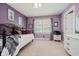 This bedroom has purple walls, carpeted floors, a window, and white trim at 12251 E 196Th St, Noblesville, IN 46060