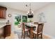 Eat-in kitchen features dining table for four and sliding doors to deck at 12251 E 196Th St, Noblesville, IN 46060
