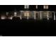 Charming home exterior at night featuring a welcoming front porch and well-lit windows at 12251 E 196Th St, Noblesville, IN 46060