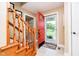 Inviting foyer with a bright red front door, tile flooring, and an elegant wooden staircase leading upstairs at 12251 E 196Th St, Noblesville, IN 46060