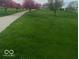 Manicured lawn and shade trees accentuate a winding driveway at 12251 E 196Th St, Noblesville, IN 46060