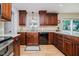 This spacious kitchen offers dark wood cabinets, stone countertops, and stainless steel appliances at 12251 E 196Th St, Noblesville, IN 46060