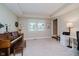 Open living room boasts tray ceiling, neutral paint, and vintage piano at 12251 E 196Th St, Noblesville, IN 46060