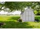 A charming shed featuring a gambrel roof, nestled in a lush green lawn with mature trees at 12251 E 196Th St, Noblesville, IN 46060