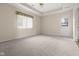 Bright bedroom with neutral carpet, a ceiling fan, and a door to the outside at 1309 Wyoming Way, Anderson, IN 46013