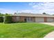 Charming brick exterior with a lush green lawn and attached garage on a sunny day at 1309 Wyoming Way, Anderson, IN 46013