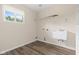 Bright laundry room with ample lighting, a utility sink, and vinyl wood-look flooring at 1309 Wyoming Way, Anderson, IN 46013