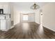Open-concept living area showcasing hardwood floors, a stylish light fixture, and connections to other rooms at 1309 Wyoming Way, Anderson, IN 46013