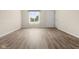 Spacious living area showcasing new flooring, a bright window, and freshly painted walls at 1309 Wyoming Way, Anderson, IN 46013