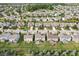 A bird's eye view of a suburban neighborhood featuring well-kept backyards, community green spaces, and serene water features at 14453 Glapthorn Rd, Fishers, IN 46037