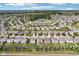 Aerial view of a suburban neighborhood showcasing well-maintained homes, community ponds, and mature trees at 14453 Glapthorn Rd, Fishers, IN 46037