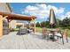 Spacious backyard featuring a paved patio with gazebo, table, chairs, and outdoor seating at 14453 Glapthorn Rd, Fishers, IN 46037