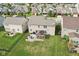 Aerial view of a manicured backyard with patio, outdoor kitchen and grill, green grass, and a dark privacy fence at 14453 Glapthorn Rd, Fishers, IN 46037