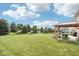 Expansive backyard featuring a lush green lawn and a patio with a cozy pergola-covered seating area at 14453 Glapthorn Rd, Fishers, IN 46037