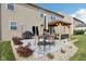 Backyard patio with a table, chairs, an umbrella, a grill, and a charming pergola-covered seating area at 14453 Glapthorn Rd, Fishers, IN 46037