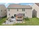 Well-maintained backyard with a stone patio, outdoor seating, and a charming pergola at 14453 Glapthorn Rd, Fishers, IN 46037