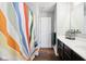 Bathroom with colorful shower curtain, dark wood vanity, and wood-look flooring at 14453 Glapthorn Rd, Fishers, IN 46037