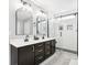 Modern bathroom boasts dual sinks, sleek fixtures, and a glass-enclosed shower with subway tile at 14453 Glapthorn Rd, Fishers, IN 46037
