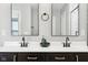 Elegant bathroom with double sinks, dark cabinets, and modern black faucets at 14453 Glapthorn Rd, Fishers, IN 46037