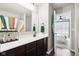 Bathroom featuring vanity with a mirror and an open doorway leading to a bedroom at 14453 Glapthorn Rd, Fishers, IN 46037