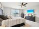 Serene bedroom features a large TV, stylish decor, and a comfortable bed at 14453 Glapthorn Rd, Fishers, IN 46037