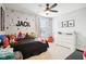 Whimsical bedroom with superhero decor, featuring a custom name wall and a dresser for storage at 14453 Glapthorn Rd, Fishers, IN 46037