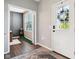 Inviting entryway featuring wood floors, a white door, and natural light at 14453 Glapthorn Rd, Fishers, IN 46037