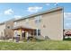 Backyard view of a two-story home featuring a patio with a pergola-covered seating area and outdoor dining at 14453 Glapthorn Rd, Fishers, IN 46037