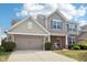 Two story home featuring brick and siding with a two car garage and manicured lawn at 14453 Glapthorn Rd, Fishers, IN 46037