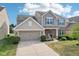 Beautiful two-story home with a two-car garage, complemented by attractive landscaping and inviting curb appeal at 14453 Glapthorn Rd, Fishers, IN 46037