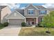 Charming two-story home with a two-car garage, brick accents, and a well-maintained front lawn at 14453 Glapthorn Rd, Fishers, IN 46037