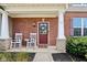 Cozy covered porch with brick pillars and rocking chairs for relaxing outdoors at 14453 Glapthorn Rd, Fishers, IN 46037