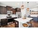 Contemporary kitchen with dark cabinetry, stainless appliances, quartz island, and stylish bar area at 14453 Glapthorn Rd, Fishers, IN 46037